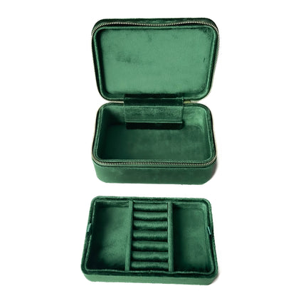 Green velvet jewelry case with compartments on a white background