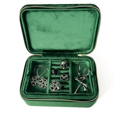 Green jewelry case with steel earrings and jewellery inside on a white background