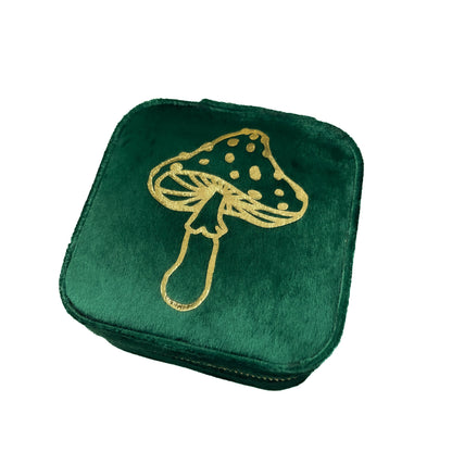 Green velvet jewelry box with gold mushroom design on a white background