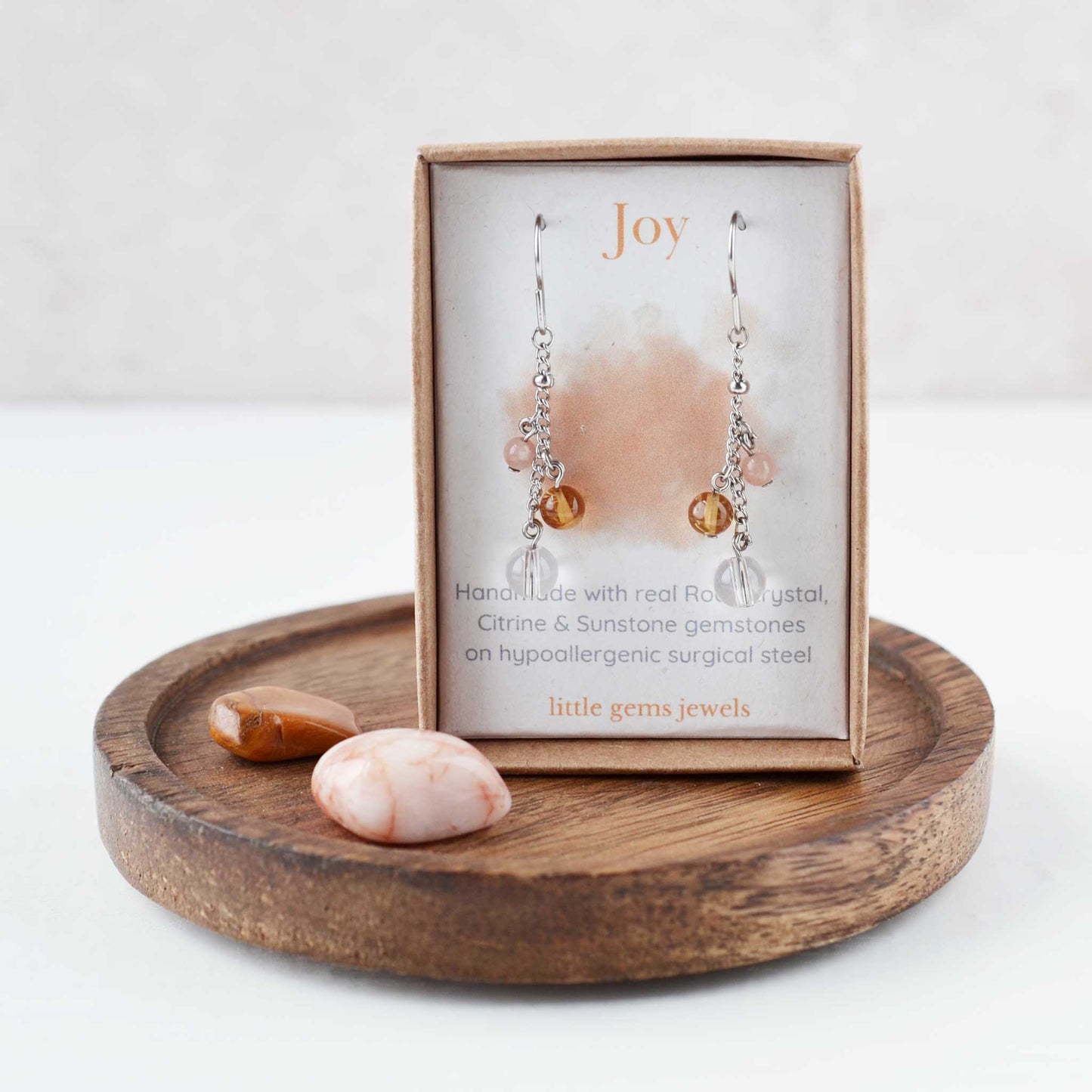 Yellow gemstone drop earrings on meaning card for Joy inside an eco friendly gift box