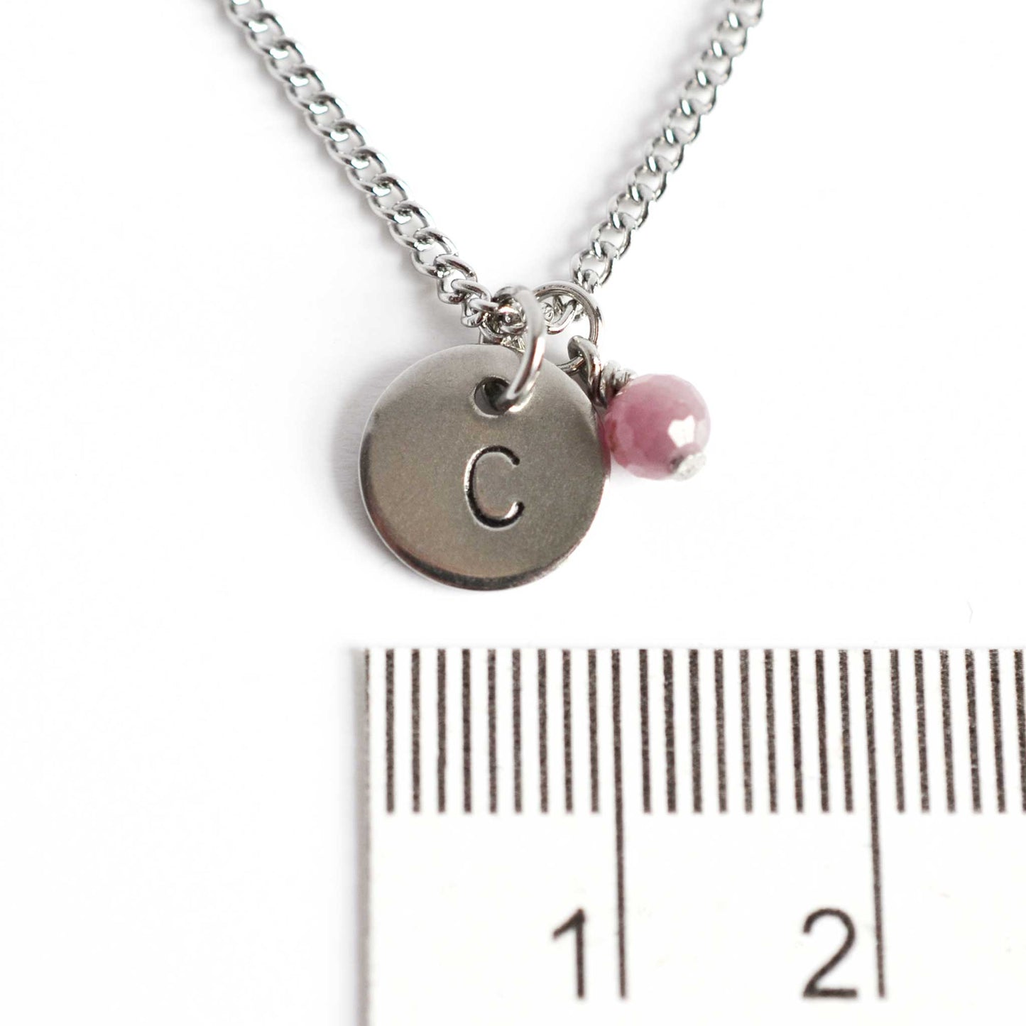 1cm diameter hand stamped initial pendant with 4mm July birthstone charm