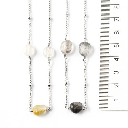 Two gemstone necklaces next to ruler 