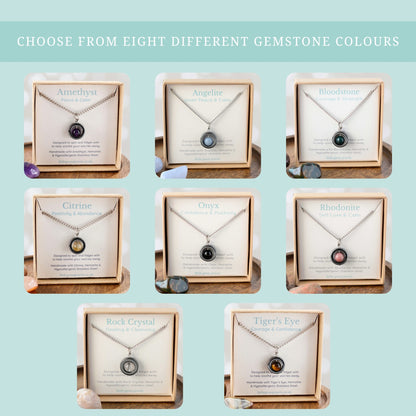 Choose from eight different gemstone colours graphic showing all eight gemstone spinner necklaces in their gift boxes.