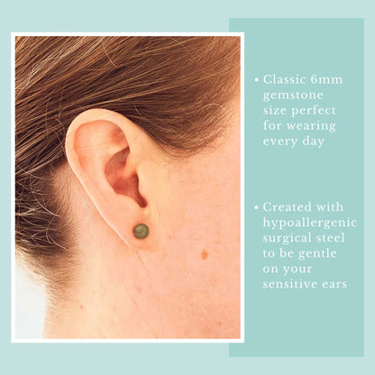 Earring worn on an ear with text about gemstone size and material