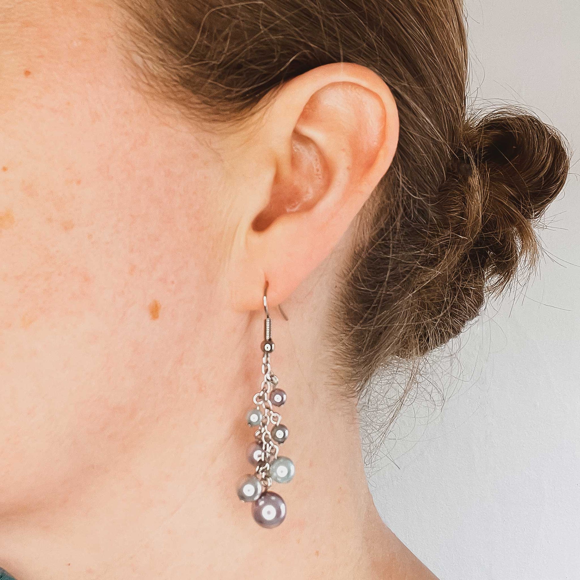 Woman wearing faux pearl cluster drop earring