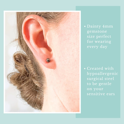Close-up of an ear wearing a small gemstone earring with text about earring size and material.