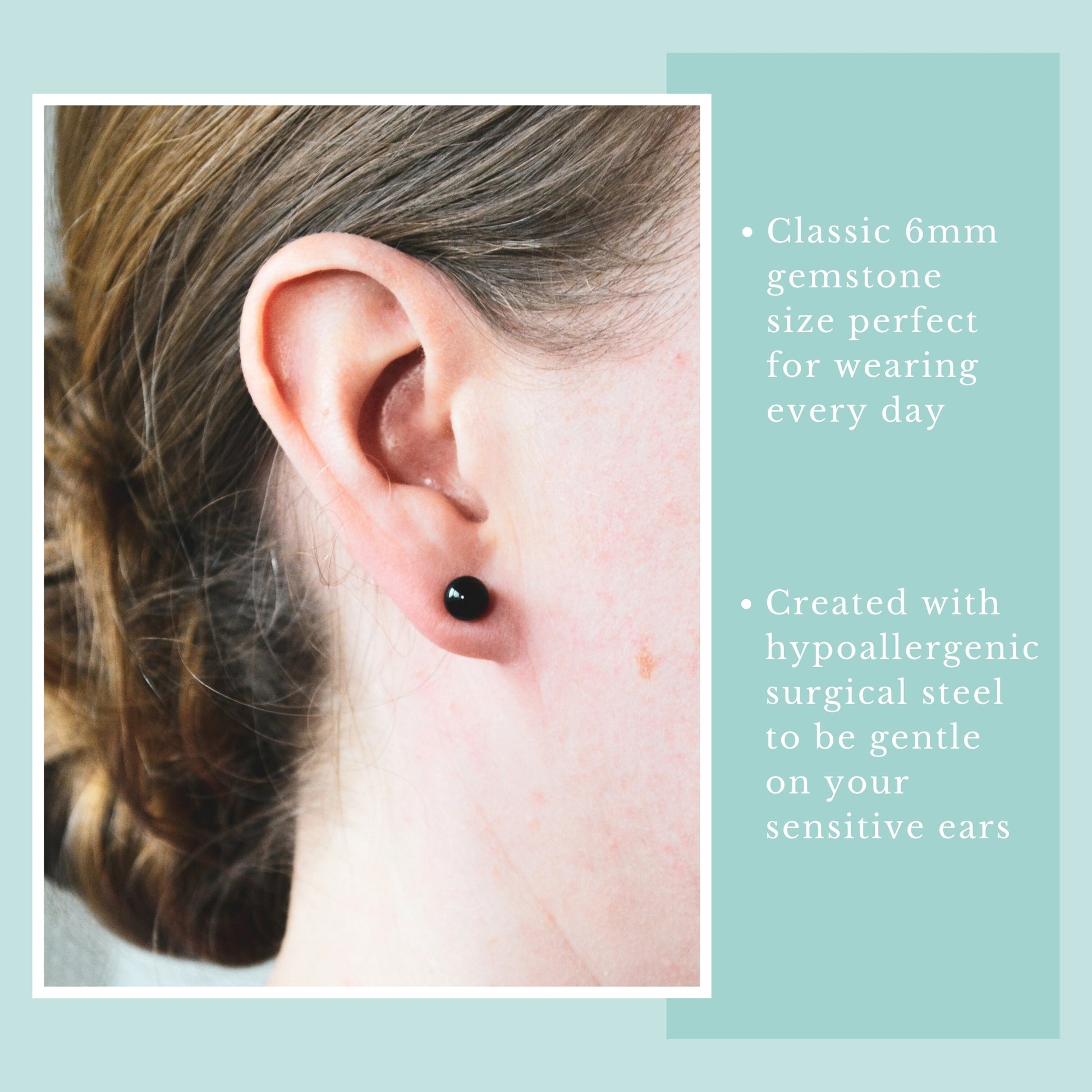 Close-up of an ear wearing a black gemstone earring with product details on a light blue background.