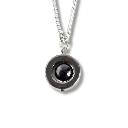 Onyx & Hematite gemstone spinner necklace on white backgound.