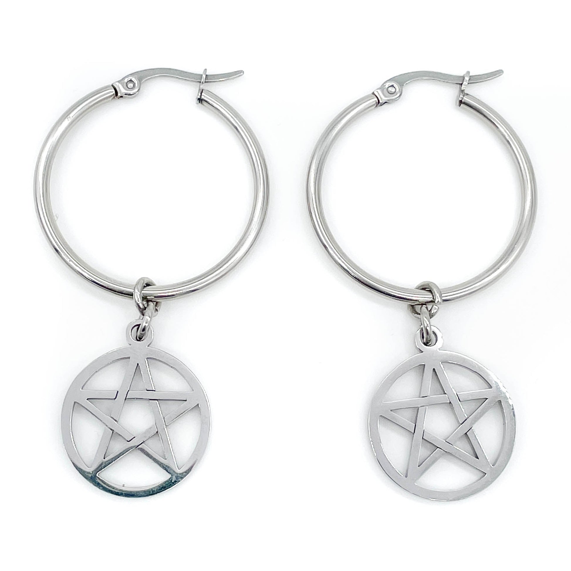 Steel hoop earrings with pentagram charms on a white background