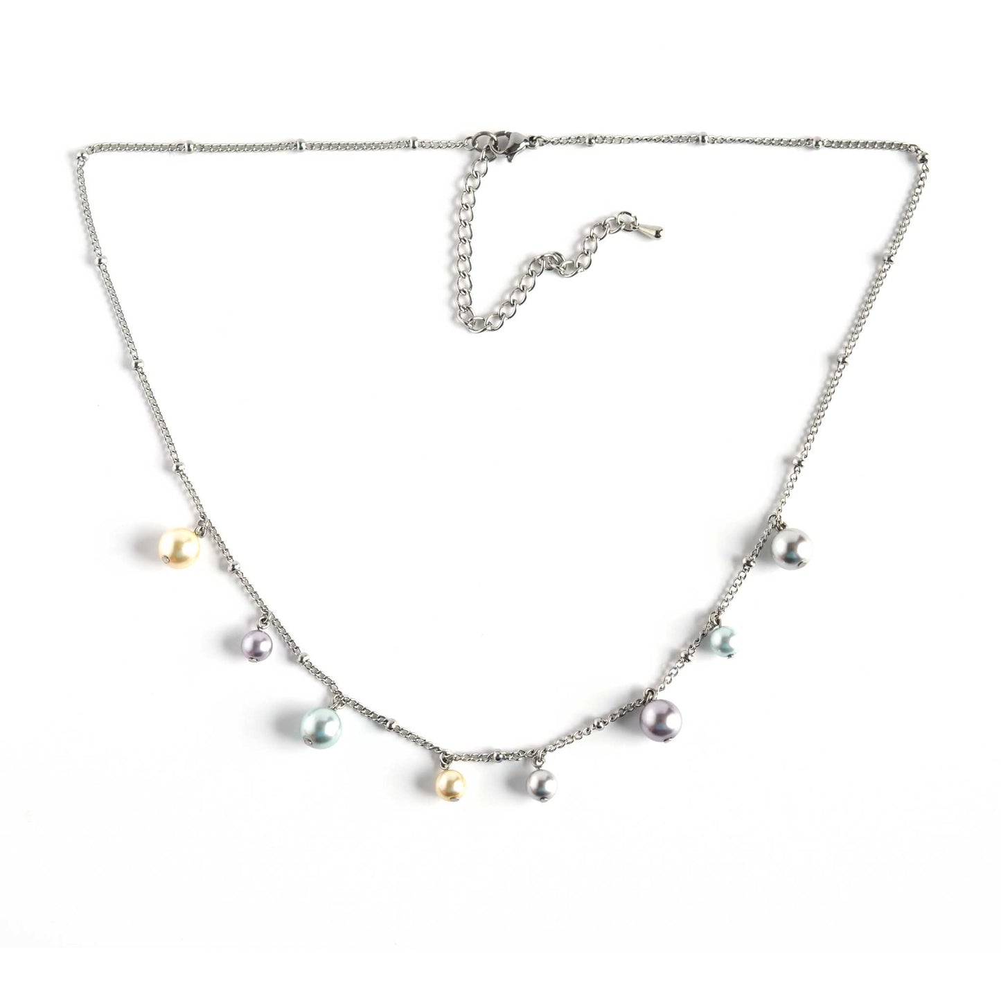 Faux pearl charms necklace with extender chain on white background.