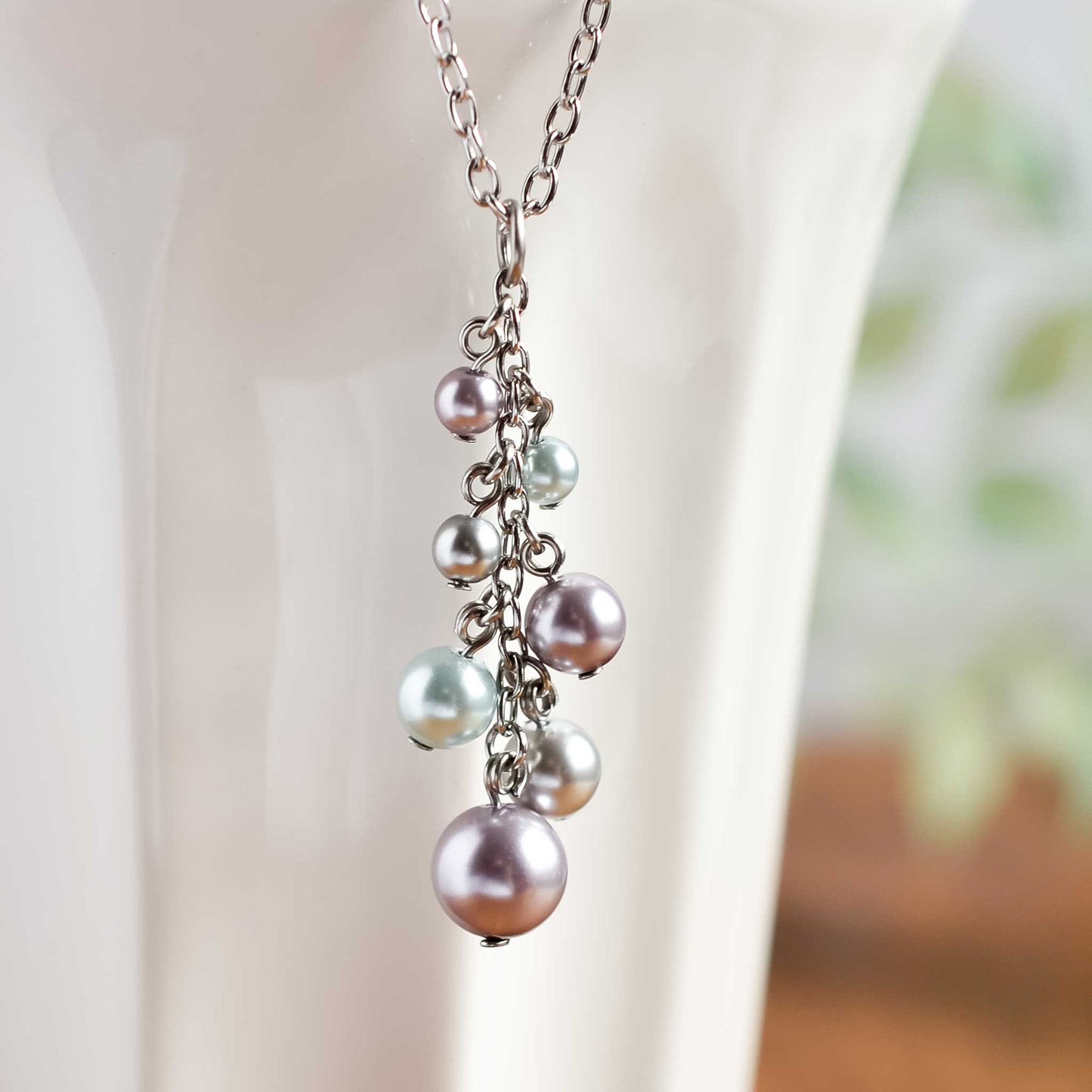 Faux pearl cluster pendant hanging from white cup
