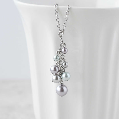 Faux pearl cluster pendant hanging from white cup