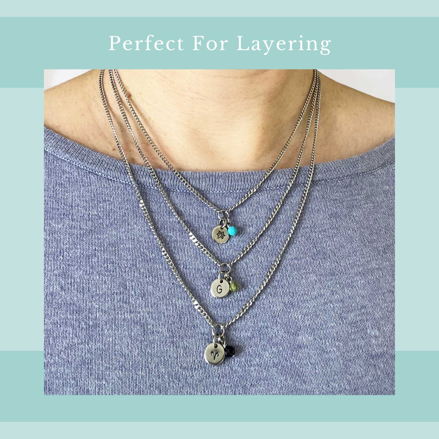 Perfect for layering graphic with an image of a woman wearing a light purple top with three different length of dainty charm necklaces around her neck