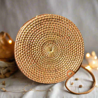 Round woven bag made of natural materials on a soft background