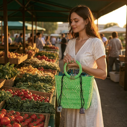 Woman holding a green handbag at an outdoor farmers market.
