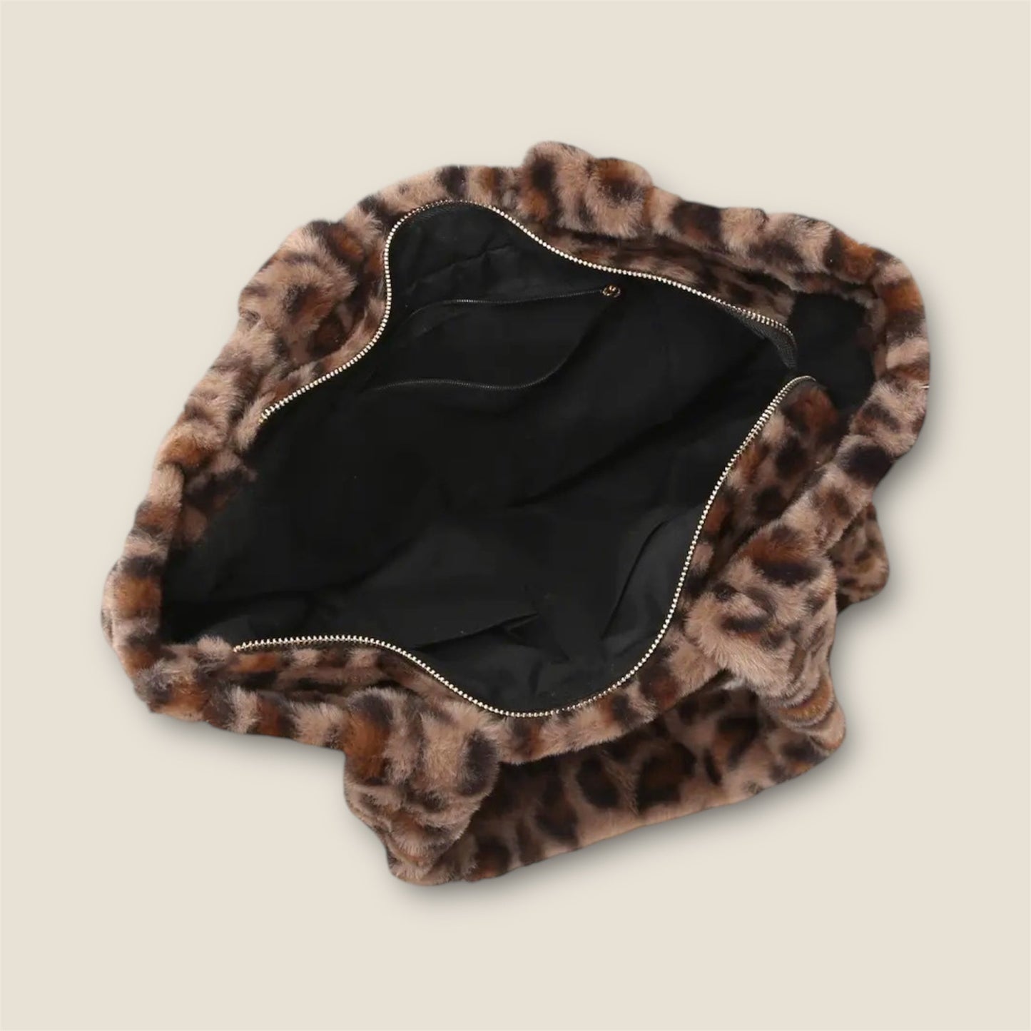 Open top of Leopard print bag with a zipper on a beige background