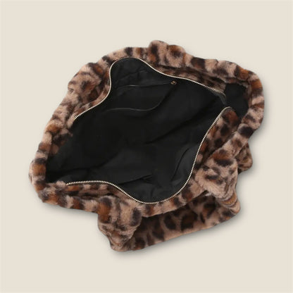 Open top of Leopard print bag with a zipper on a beige background