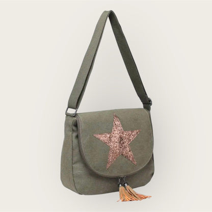 Green shoulder bag with a star design and tassel on a white background