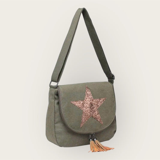 Green shoulder bag with a star design and tassel on a white background