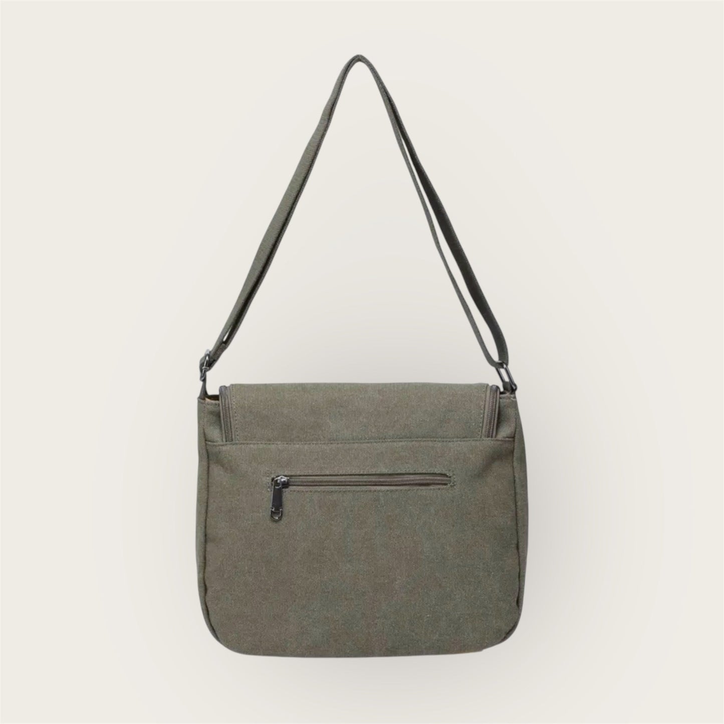 Back of green shoulder bag with a zipper on a white background