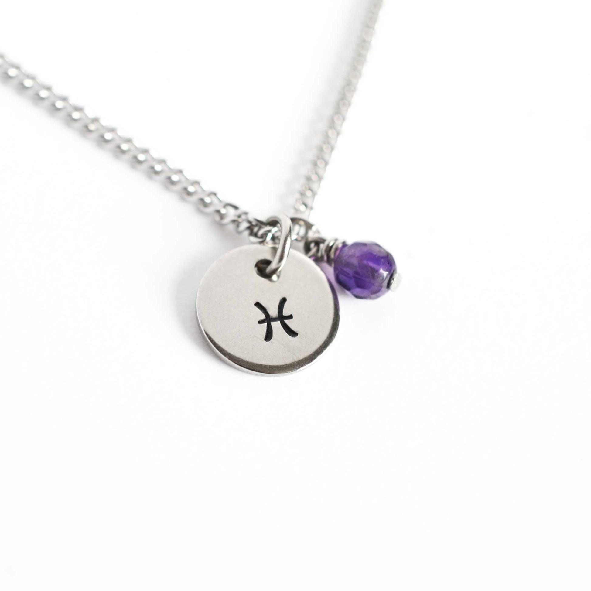 Pisces Zodiac pendant necklace with tiny Amethyst gemstone charm on white background