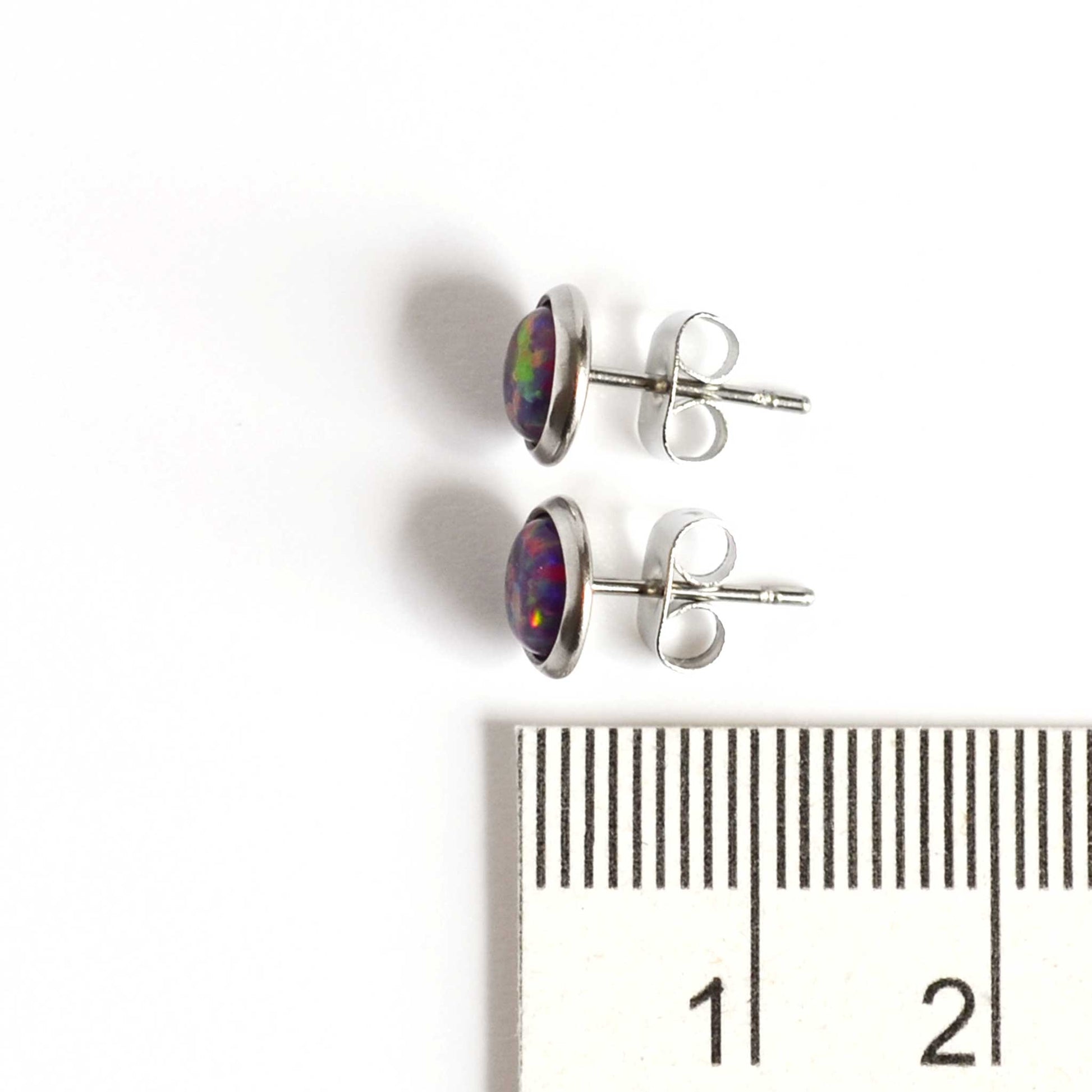 Purple Opal stud earrings next to ruler