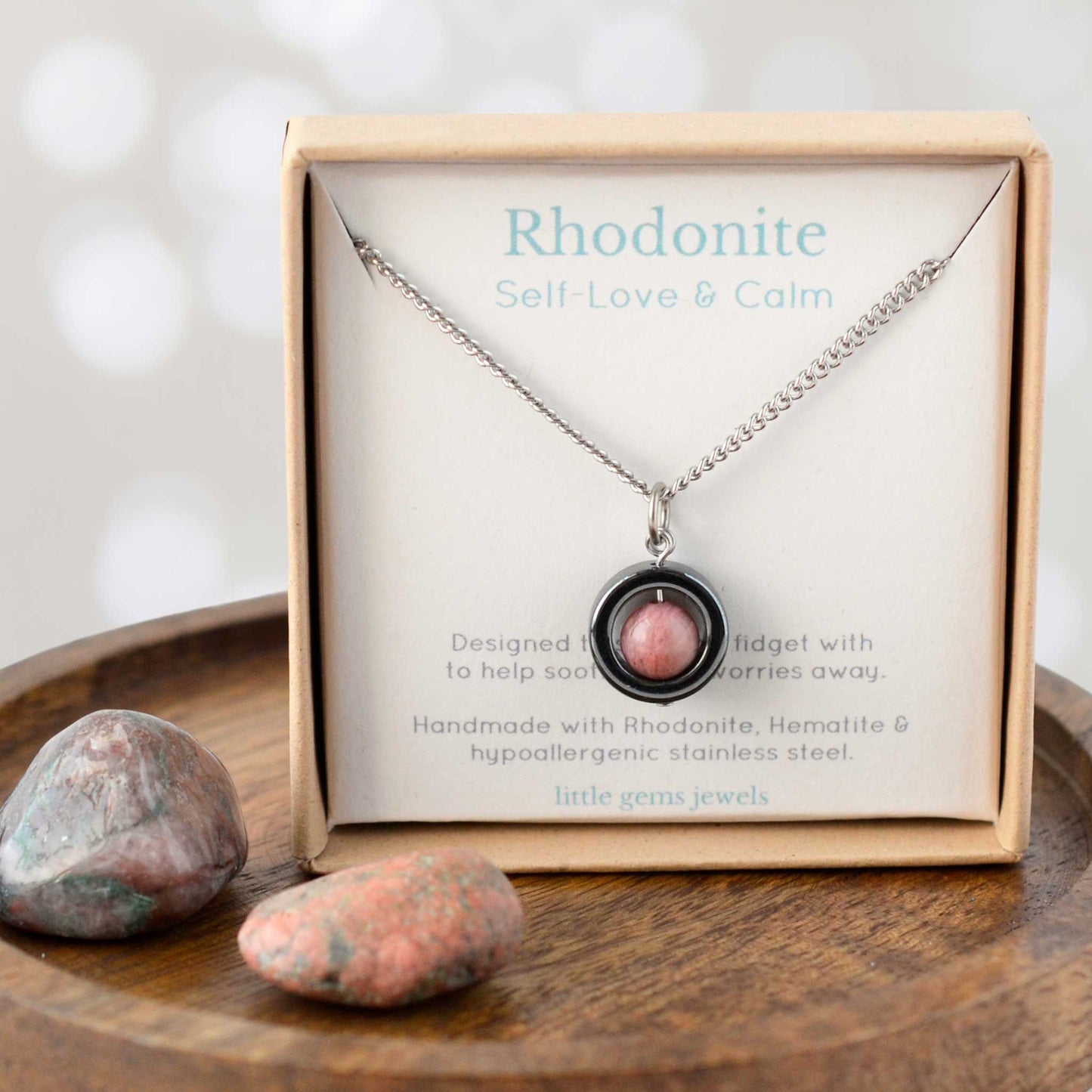 Rhodonite gemstone spinner necklace in eco friendly gift ox.