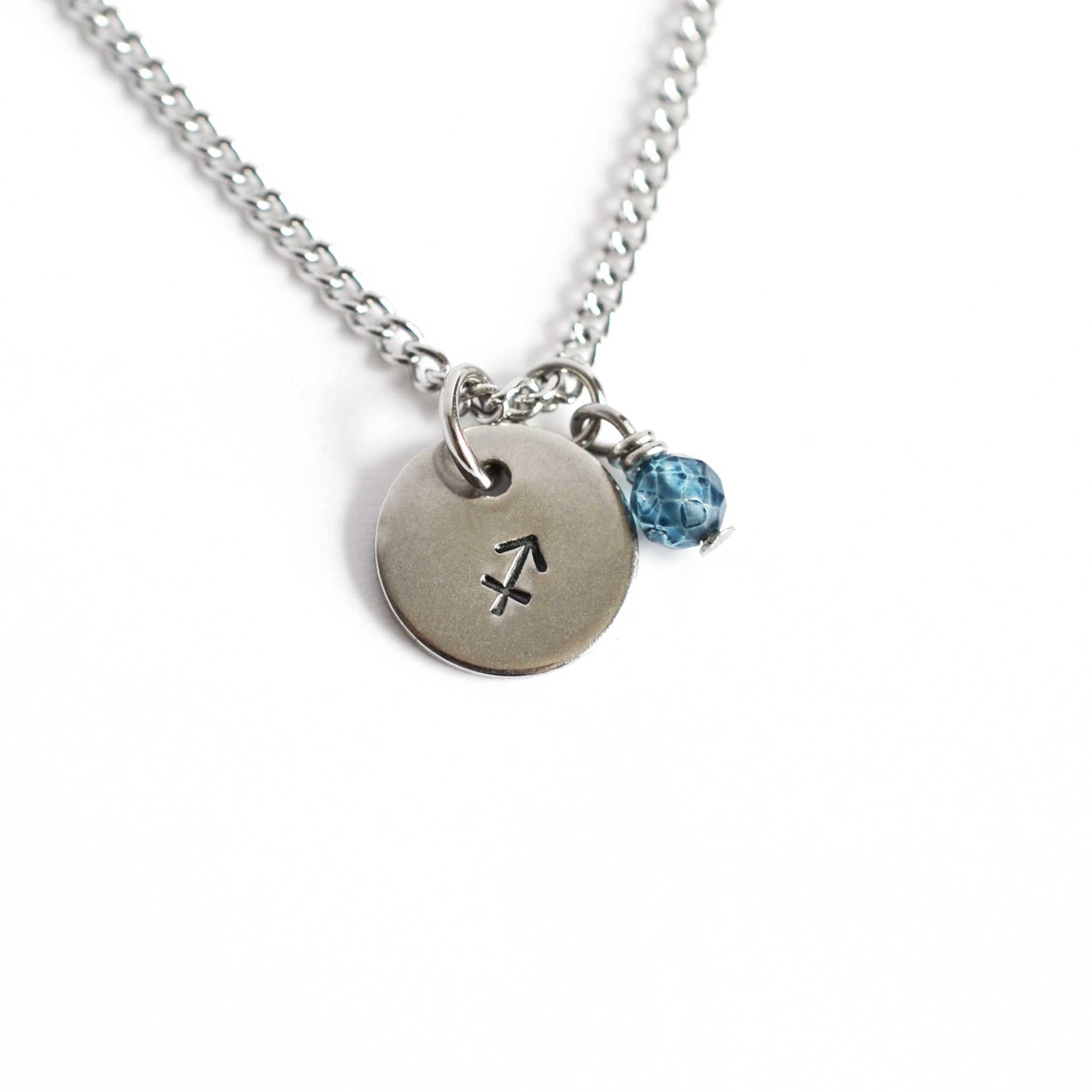 Sagittarius Zodiac pendant necklace with tiny Topaz gemstone charm on white background