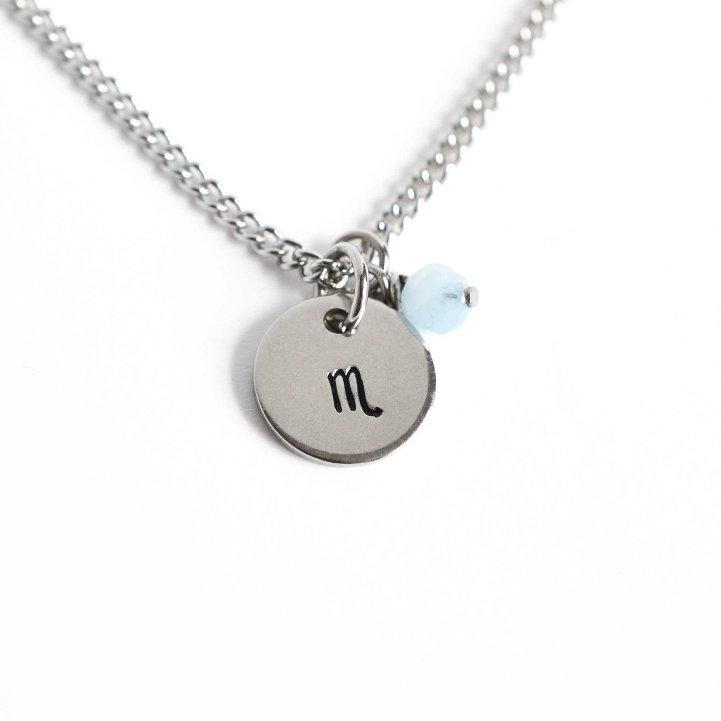 Scorpio Zodiac pendant necklace with tiny Aquamarine gemstone charm on white background