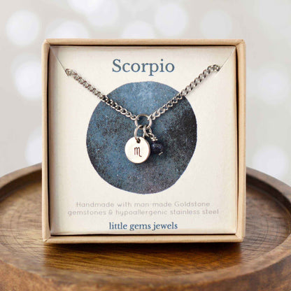 Dainty Scorpio zodiac sign necklace in eco-friendly gift box on wooden coaster