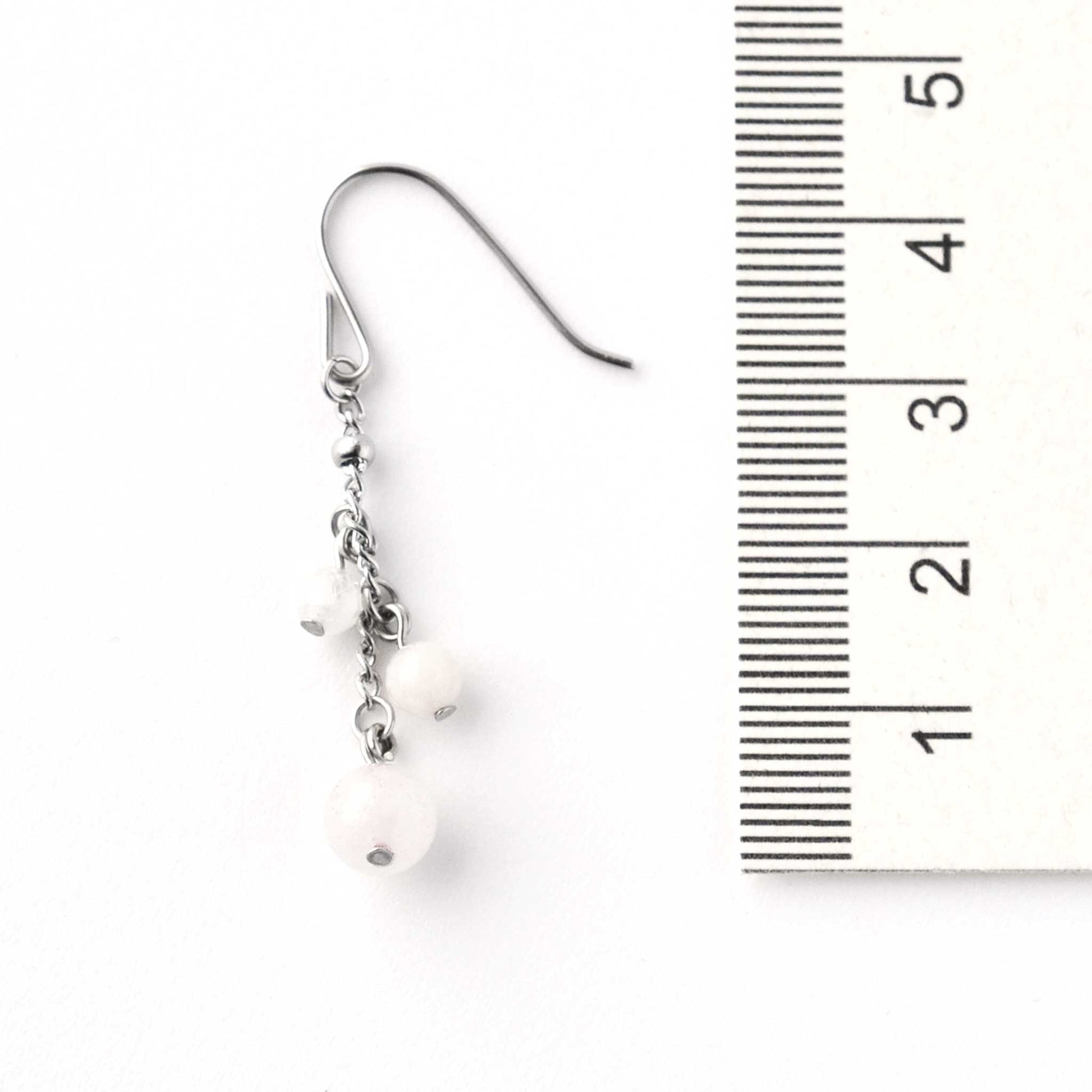 Pale pink gemstone drop earring next to ruler showing 4.5cm length