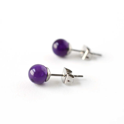 Side view of purple Amethyst bead earrings with surgical steel posts on a white background