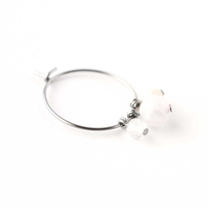 Close up of Rainbow Moonstone, Rose Quartz & Pink Opal round gemstone beads hanging on hoop earring