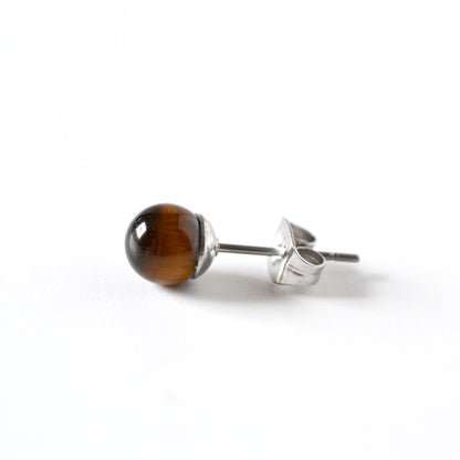 A single stud earring featuring a polished brown tiger's eye bead on a surgical steel post and butterfly back, shown on a clean white background.