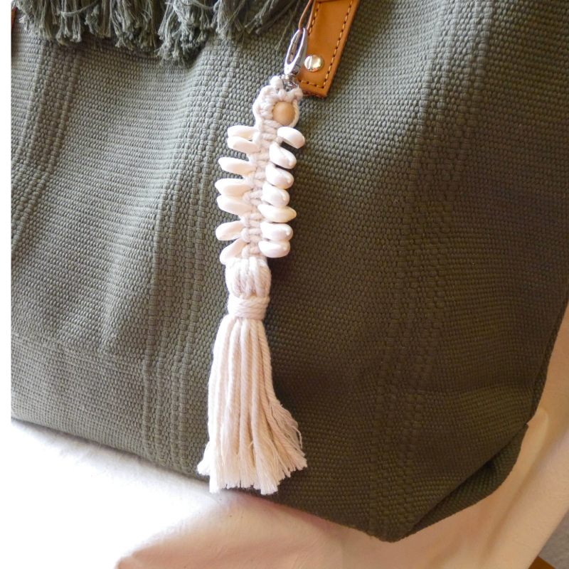 Beaded tassel keychain attached to a green bag