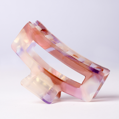 Multicolored hair clip on a light purple background