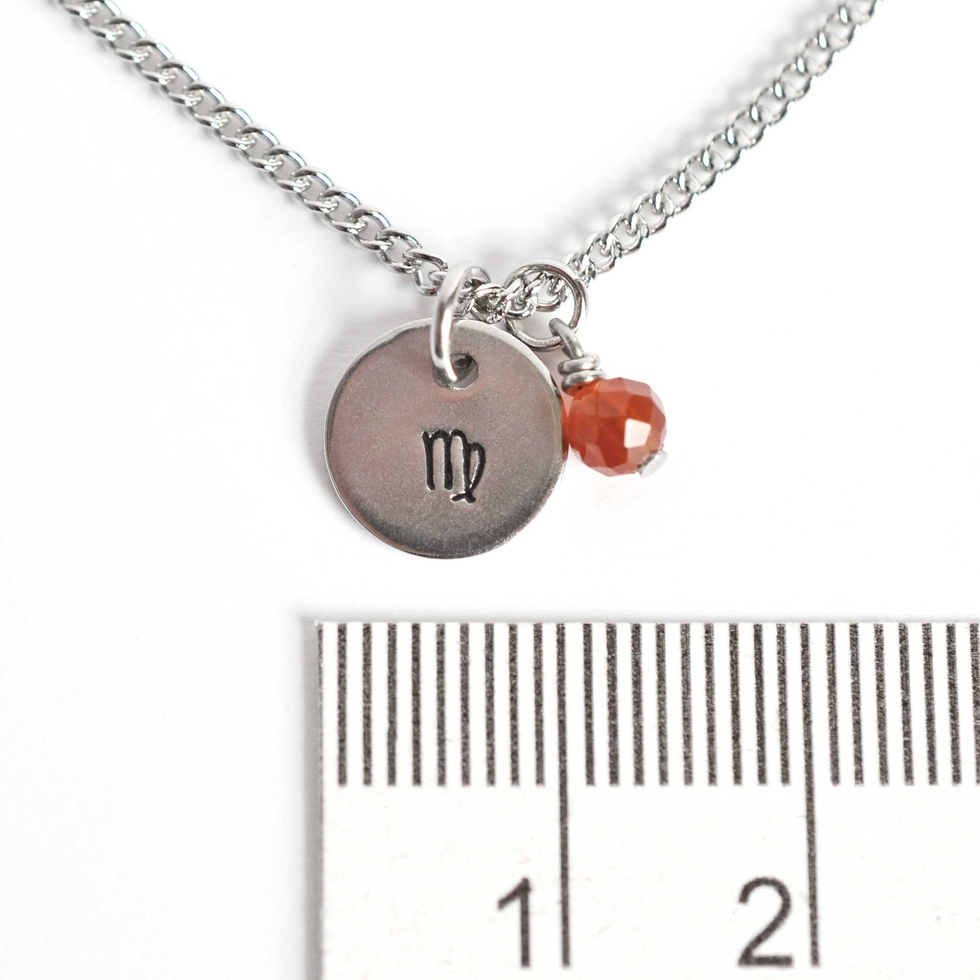 1cm diameter disc pendant with hand stamped Virgo zodiac sign and 4mm Carnelian gemstone charm