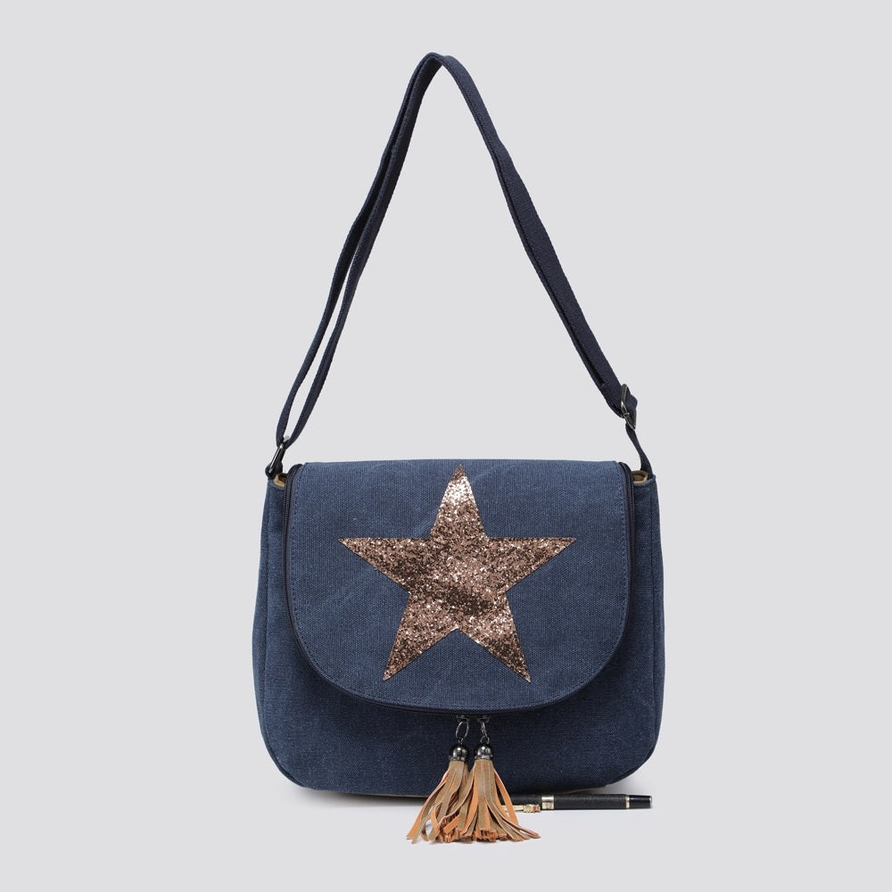 Blue handbag with a star design and tassel on a light gray background