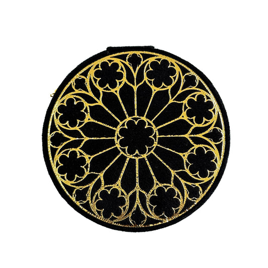 Round black and gold decorative box with gold pattern on a white background