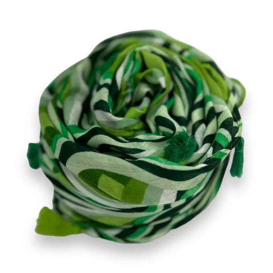 Green and white patterned fabric rolled up on a white background