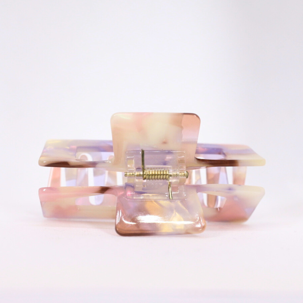 Translucent pink and clear hair clip on a white background