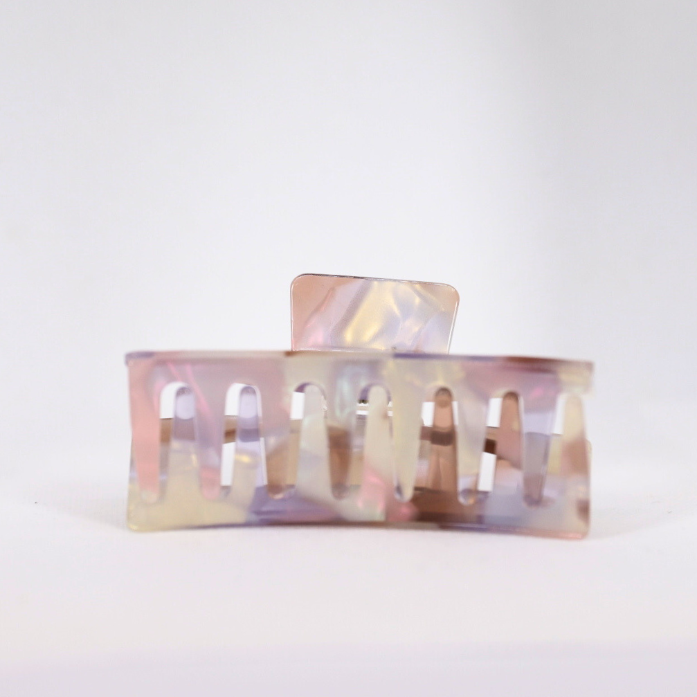 Iridescent hair clip on a light gray background