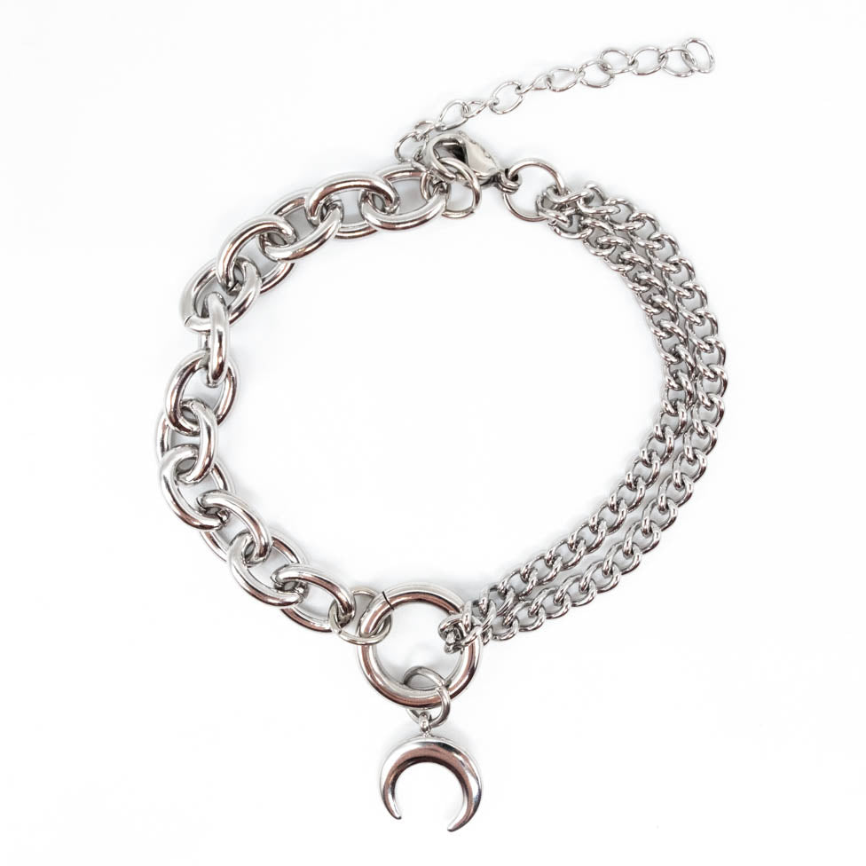 Stainless steel chain bracelet with a crescent moon charm on a white background