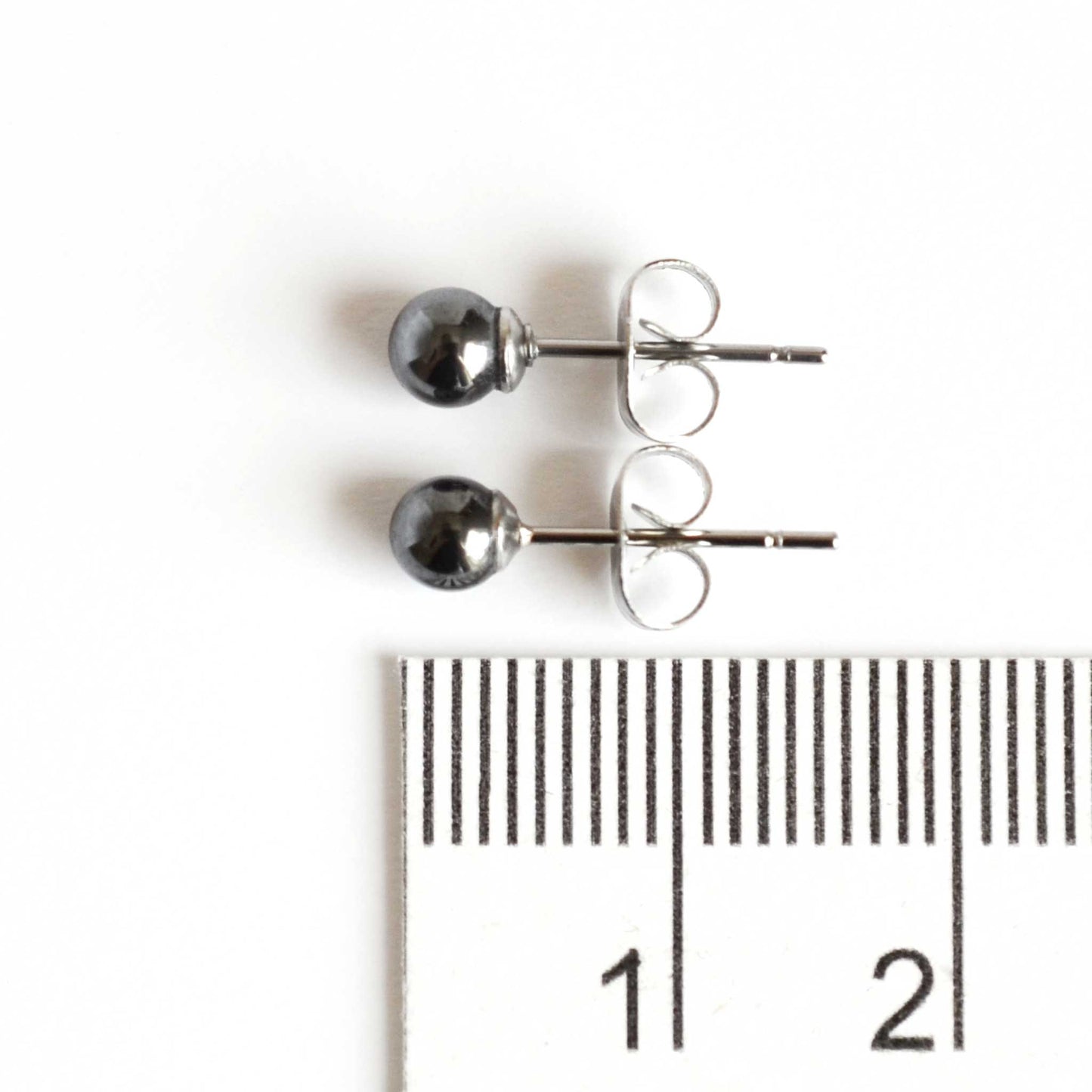 4mm Hematite earrings next to ruler