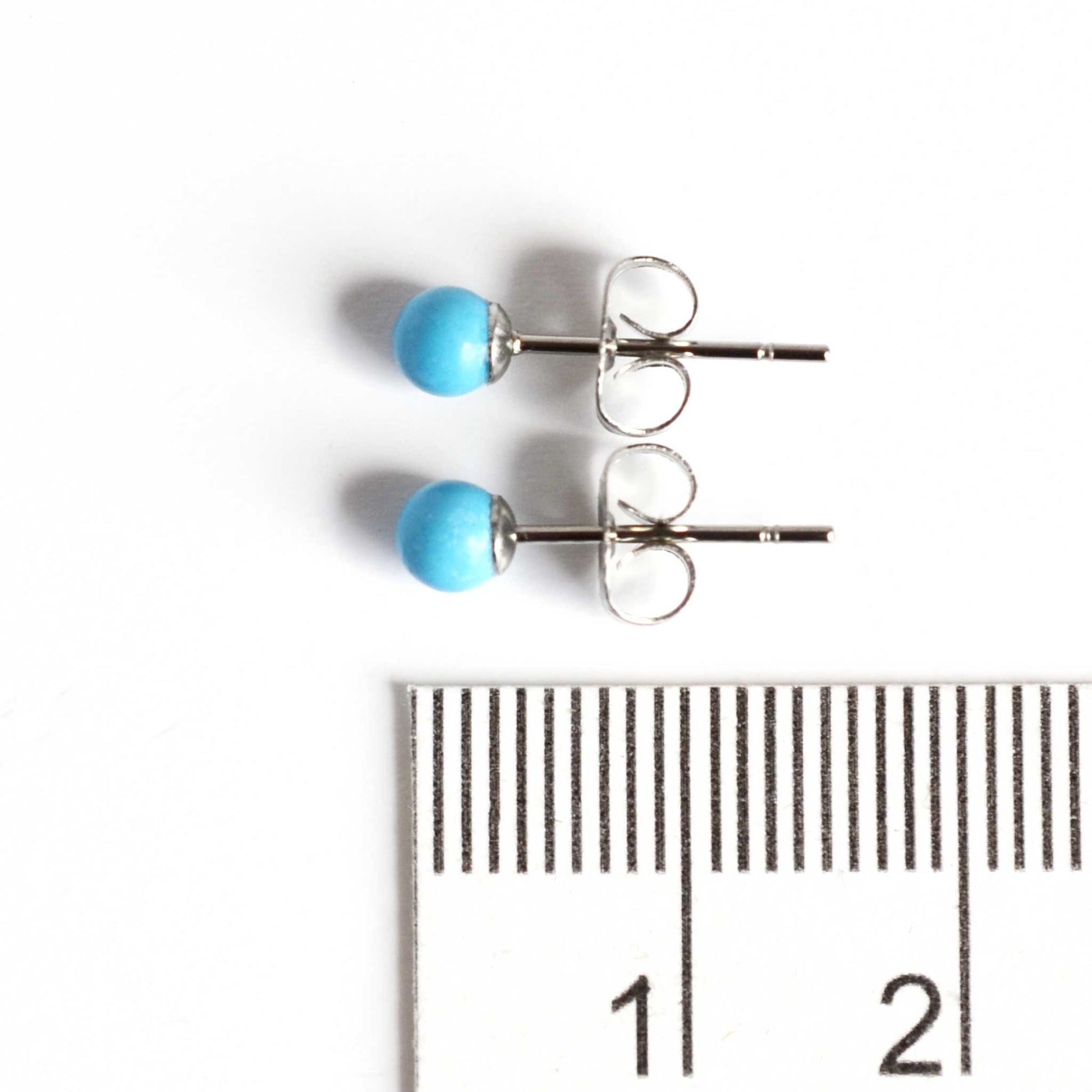 4mm small Turquoise earrings next to ruler