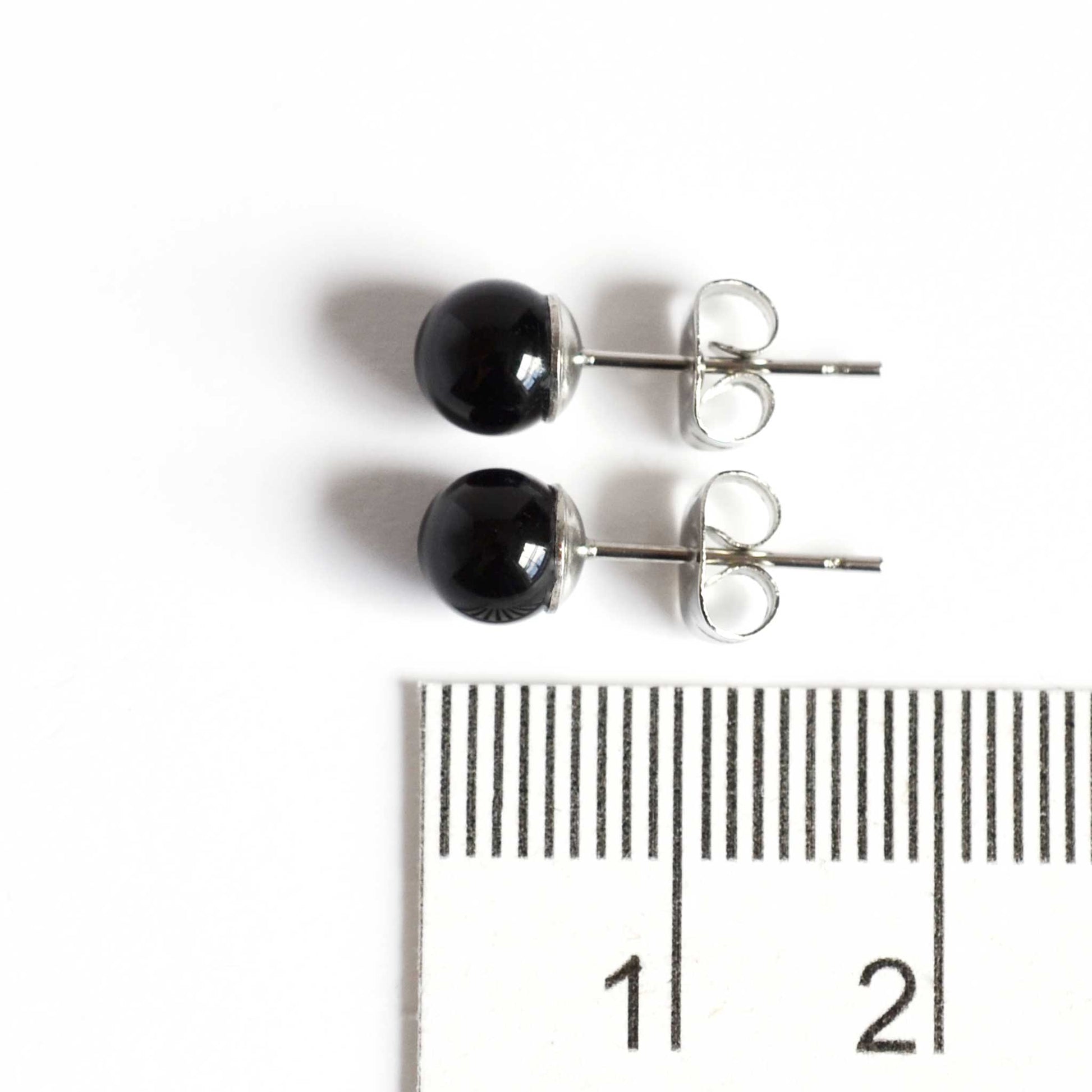 6mm black Onyx earrings next to ruler