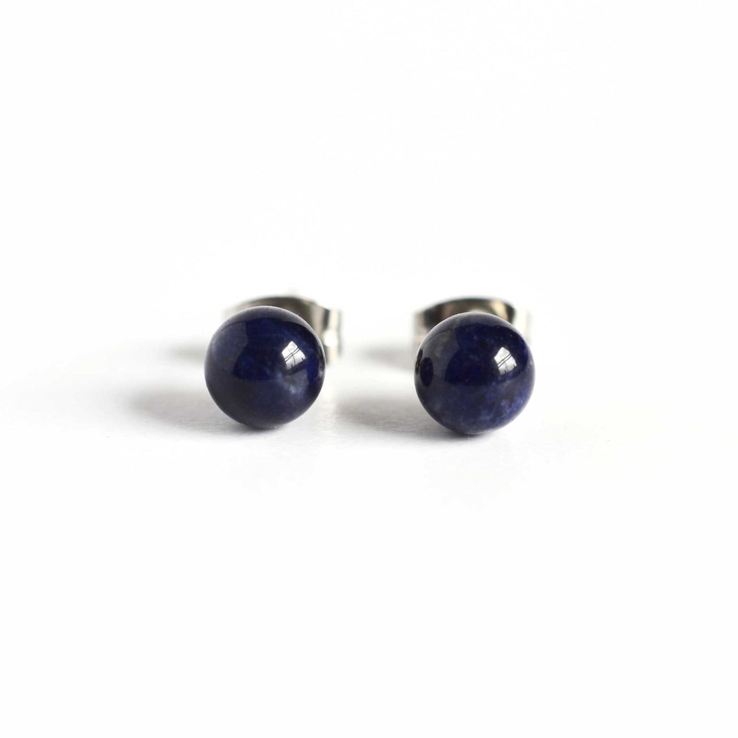 Front view of Sodalite stud earrings blue stone on white background