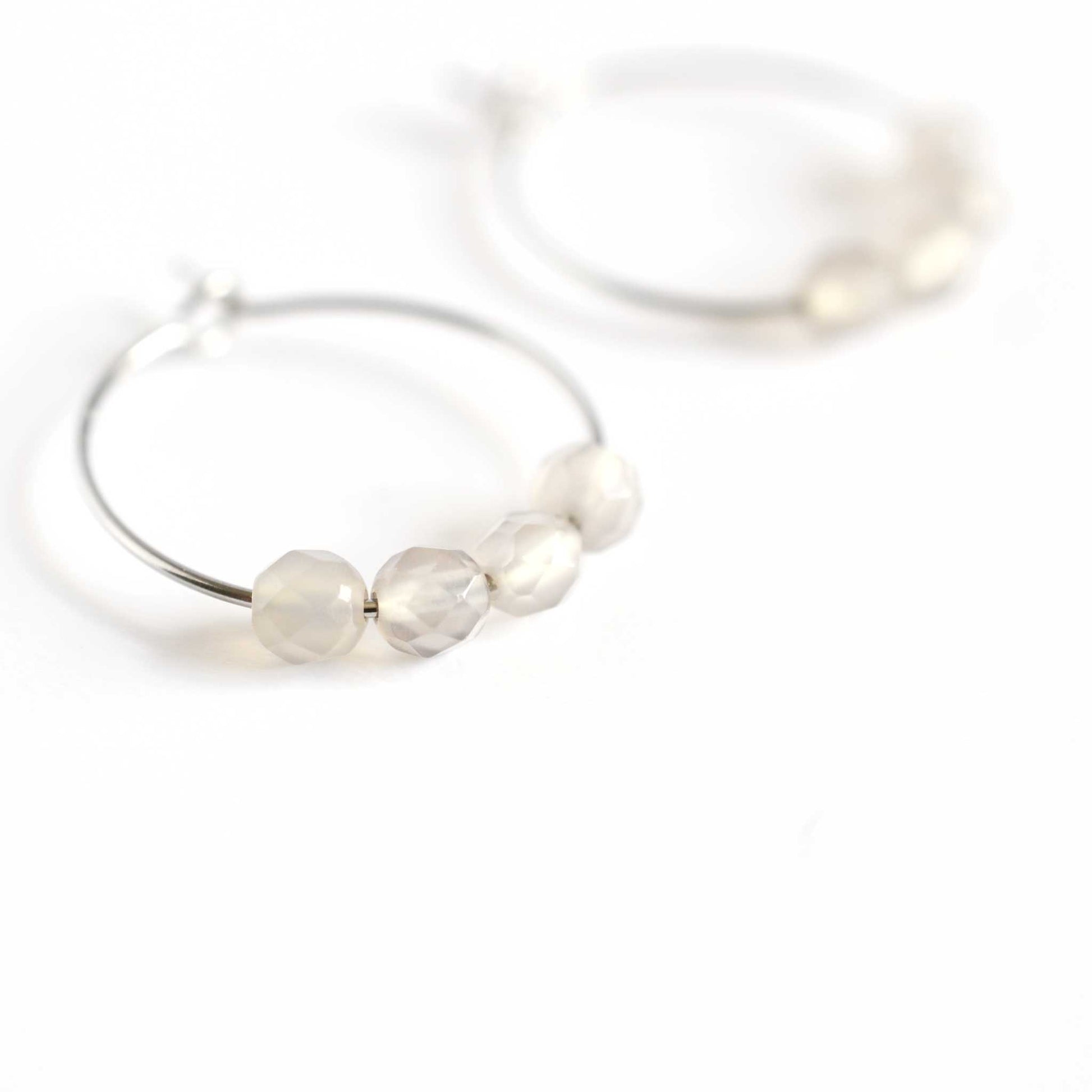 Close up of grey Agate hoop earrings with four small round faceted smoky grey Agate gemstone beads