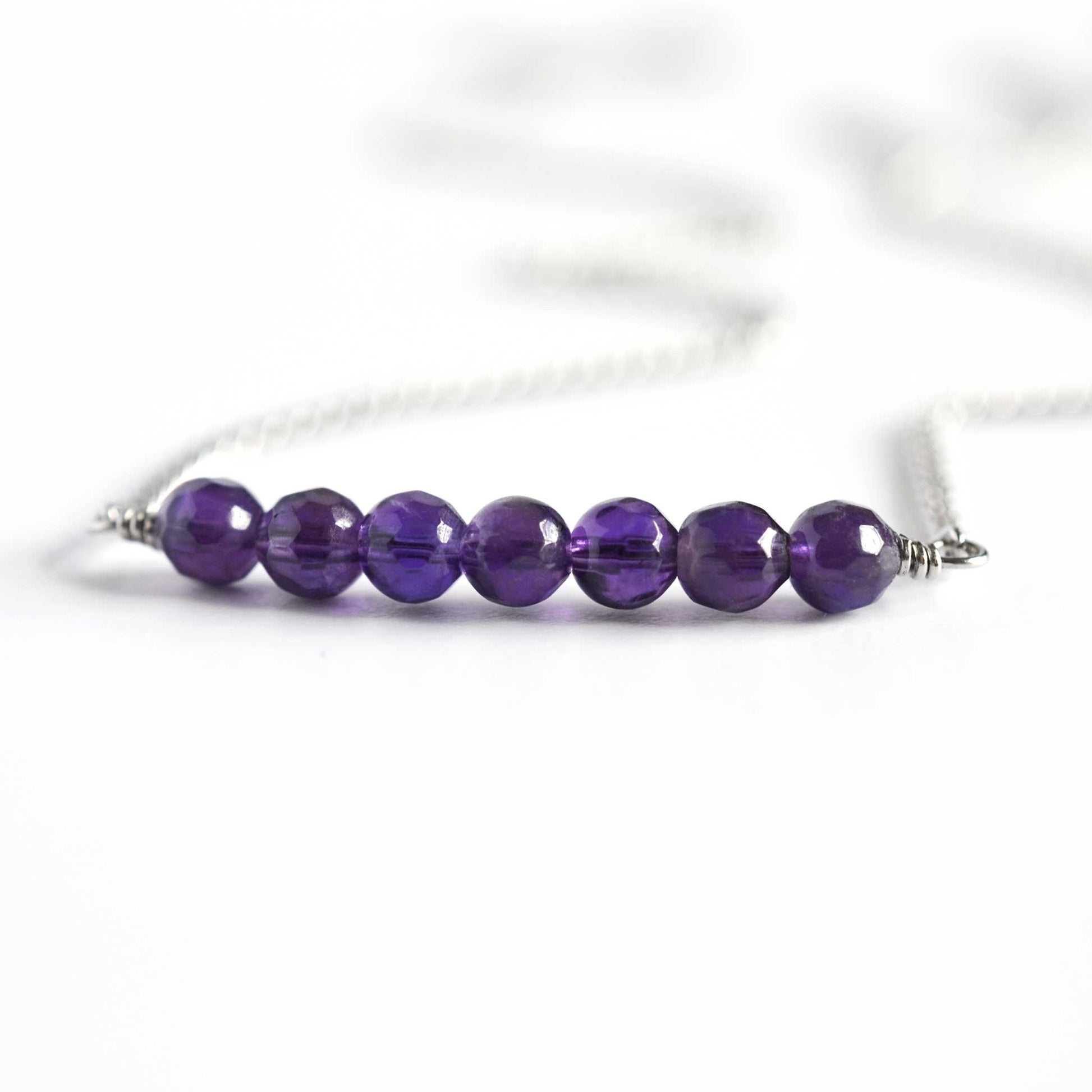 Close up of Amethyst necklace UK made with seven small round faceted purple Amethyst beads