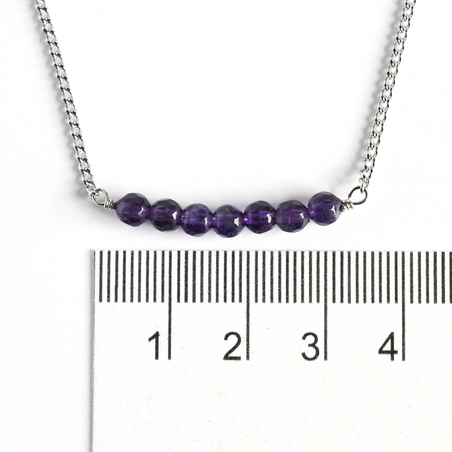 Dainty Amethyst necklace with 4mm gemstone beads next to ruler